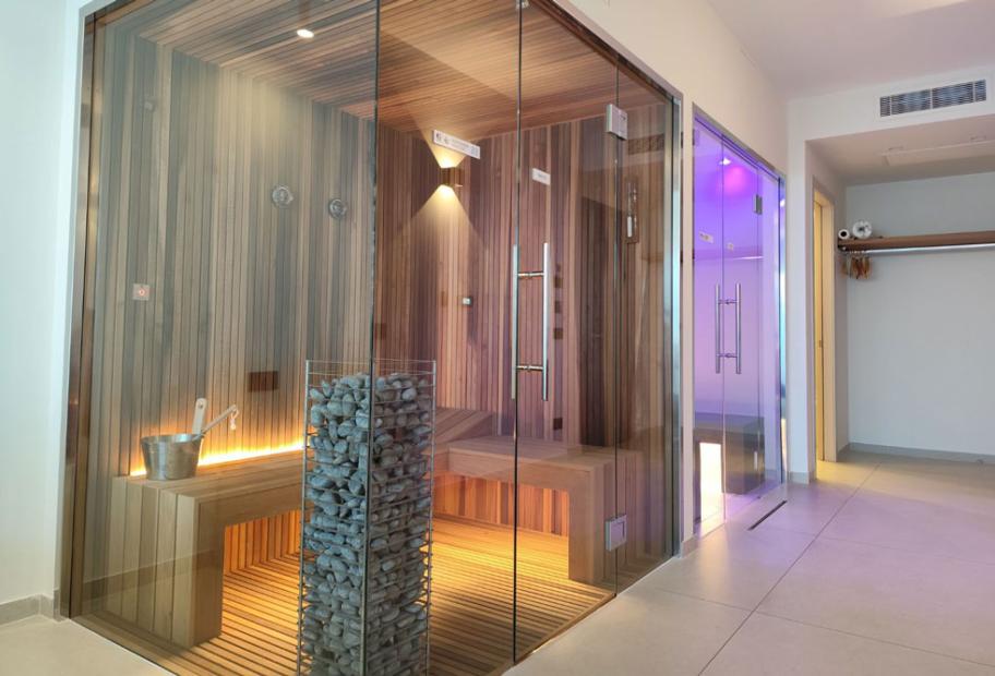 Wellness area with sauna and steam room, modern design and cozy lighting.